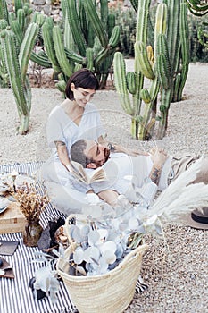 Couple on romantic date lay on picnic blanket