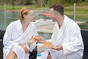 Couple in roof top restaurant with view to lake