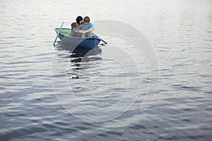 Couple In Rowboat At Lake