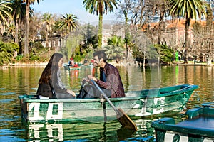 Couple rowing on small boat.