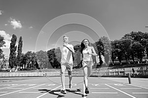 Couple running on arena track.