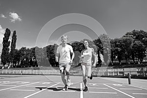 Couple running on arena track