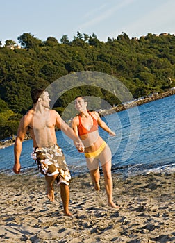 Couple running on beach