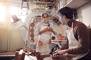 Couple Running Bespoke Pottery Business Working In Ceramics Studio Together