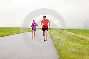 Couple running on country road