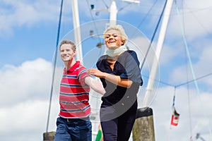 Couple running at marina pier