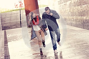 Couple running in the rain