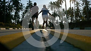 Couple running on sunny road between the palm trees. slow motion. 1920x1080