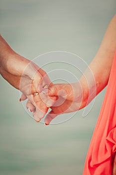 Couple`s hands with paper ships as a simbol of making a wish