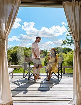 couple on safari in South Africa, Asian women and European men at a tented camp lodge during safari