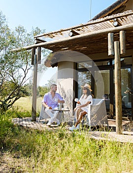 couple on safari in South Africa, Asian women and European men at a tented camp lodge during safari