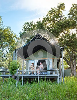 couple on safari in South Africa, Asian women and European men at a tented camp lodge during safari