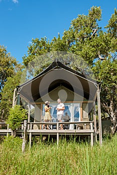 couple on safari in South Africa, Asian women and European men at a tented camp lodge during safari