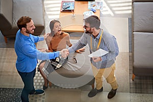 Couple with salesman in store furniture for the house