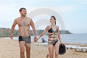 Couple on sand seashore in cloudy day