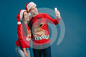 couple in santa hats and christmas