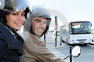 Couple on scooter in a crossroad