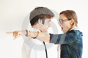 Couple, screaming and fight, divorce and pointing in studio isolated on white background. Woman shout, breakup and man