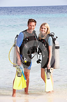 Couple With Scuba Diving Equipment Enjoying Beach Holiday