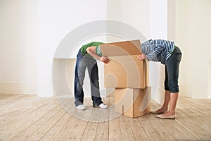 Couple Searching Into Cardboard Box