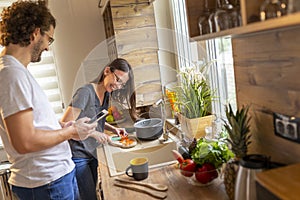 Couple searching for recipes and preparing meal