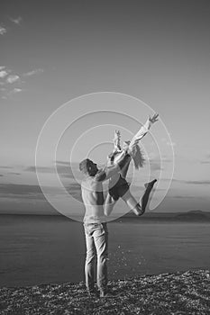 Couple secrets fantasy. Couple in love dancing, having fun, sea and skyline background. Couple in love stand on beach