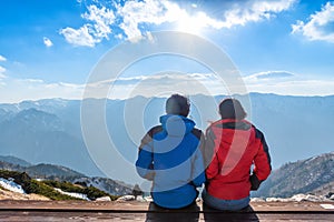 A couple is seeing the scenery of Mount Tsubakuro Dake at sunset. Mountain range of Norther Japan Alps Chubu-Sangaku Park