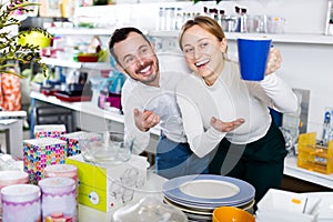 Couple selecting crockery in store