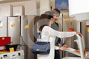 Couple selecting new clothes washer