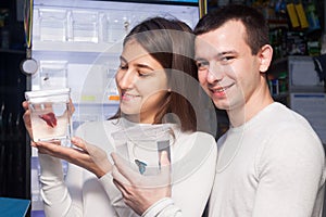 Couple selecting tropical fish