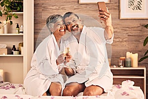 Couple, selfie and champagne toast for spa massage, vacation or holiday celebration, love and social media. Wine glasses