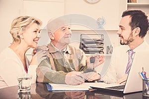 Couple selling car in bank