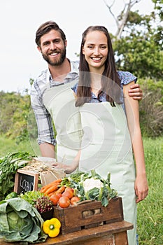 Couple selling organic vegetables at market