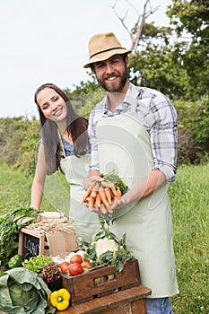 Couple selling organic vegetables at market