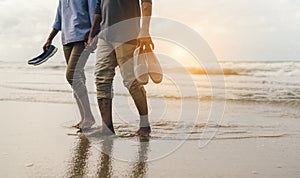 Couple senior elder retire resting relax walking at sunset beach