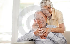 Couple, senior and hug or sofa in portrait, home and relax together for bonding and smile. Elderly people, embrace and