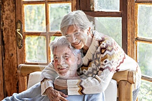 Couple of senior mature people enjoy time at home together hugging and loving. Portrait of elderly old man and woman in love.