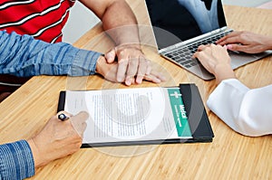 Couple senior patient in office filling out medical document form on a clipboard with doctor, Patient listening receiving in