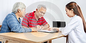 Couple senior patient in office filling out medical document form on a clipboard with female doctor, Patient listening receiving