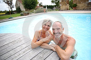 Couple of seniors enjoying swimming pool