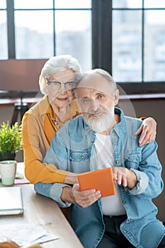 Couple of seniors surfing the internet using a tablet