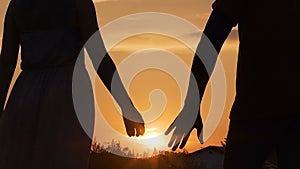 Couple separating their hands at sunset, love story ending, family break-up