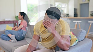 Couple, separation and argument on sofa in disagreement, conflict or divorce in living room dispute at home. Angry or