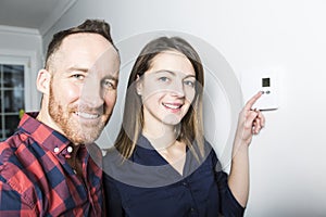 Couple set the thermostat at home