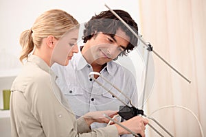 Couple setting up an antenna