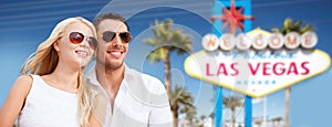Couple in shades over las vegas sign at summer