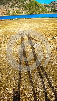 Couple shadow on beach, sunset lighting. Mediterranean Sea, Turkey.