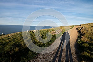 Couple shadow on coastal walking track