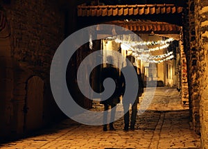 Couple Shadows at the street in Old Town in Tallinn city. Christmas decorations at street.