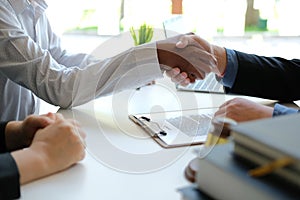 Couple shaking hands to realtor mortgage insurance broker lawyer. customer handshaking with financial advisor for advice